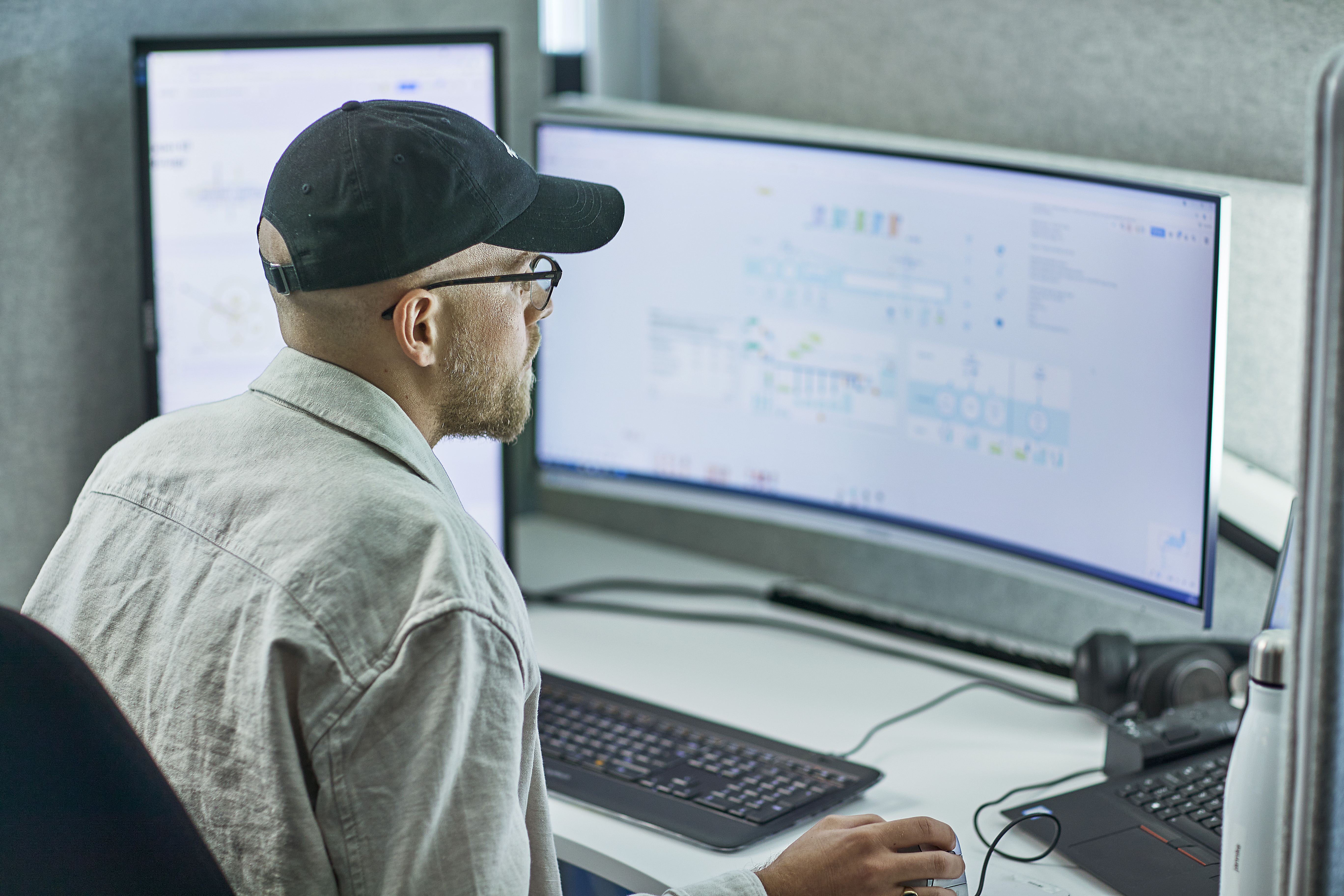 Bilde av en mann som ser på pc-skjermer