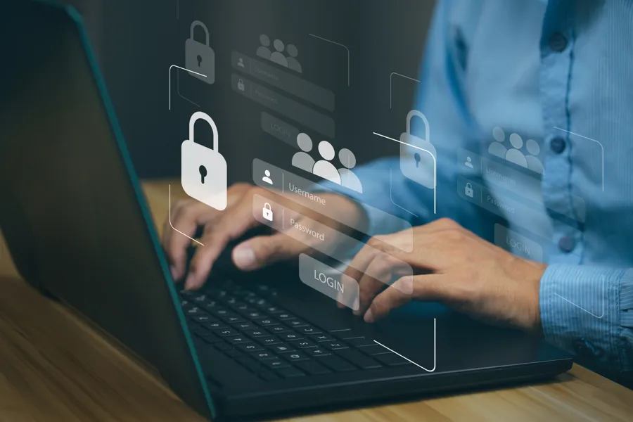 Person som skriver på en bærbar PC, med transparente ikoner for lås, brukere og innloggingsfelt som symboliserer digital sikkerhet og pålogging.